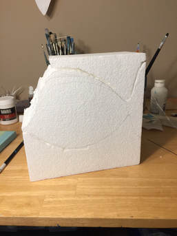 Block of foam with shape drawn on it